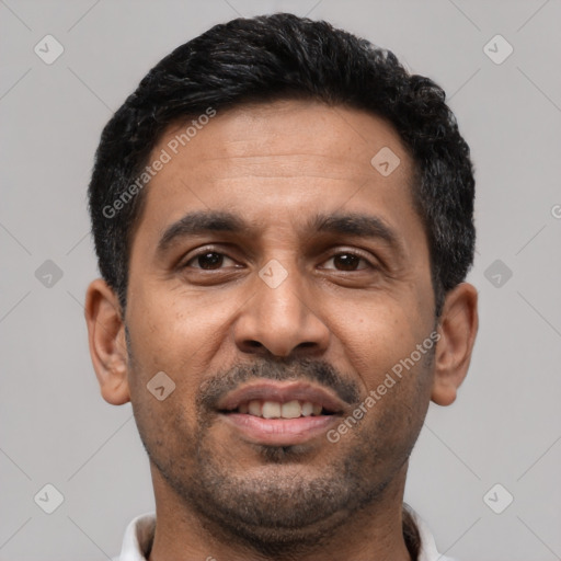 Joyful latino adult male with short  black hair and brown eyes