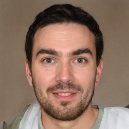 Joyful white young-adult male with short  black hair and brown eyes