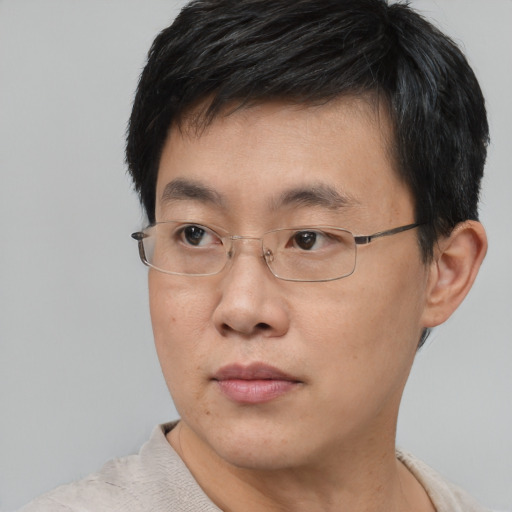 Neutral asian adult male with short  black hair and brown eyes