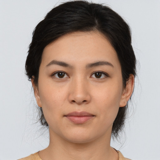 Joyful asian young-adult female with medium  brown hair and brown eyes
