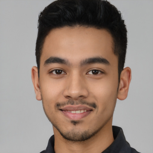 Joyful latino young-adult male with short  black hair and brown eyes