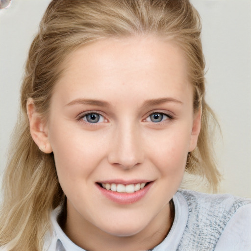 Joyful white young-adult female with medium  brown hair and blue eyes