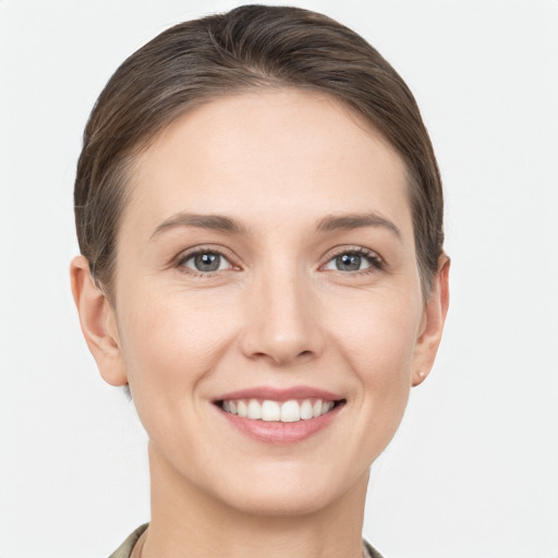 Joyful white young-adult female with short  brown hair and grey eyes