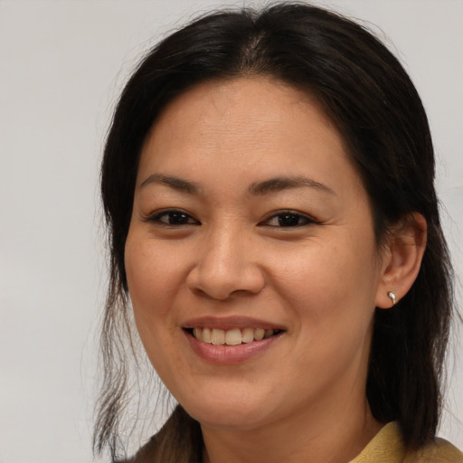 Joyful asian young-adult female with medium  brown hair and brown eyes