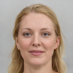 Joyful white young-adult female with medium  brown hair and blue eyes