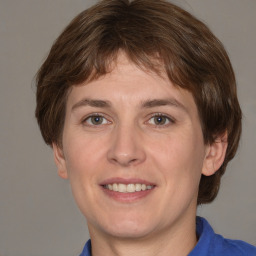 Joyful white adult female with medium  brown hair and grey eyes