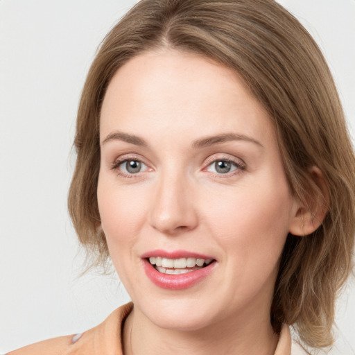 Joyful white young-adult female with medium  brown hair and blue eyes