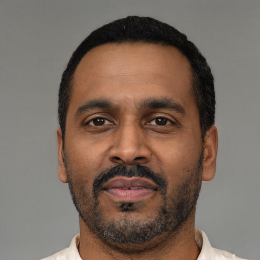 Neutral latino adult male with short  black hair and brown eyes