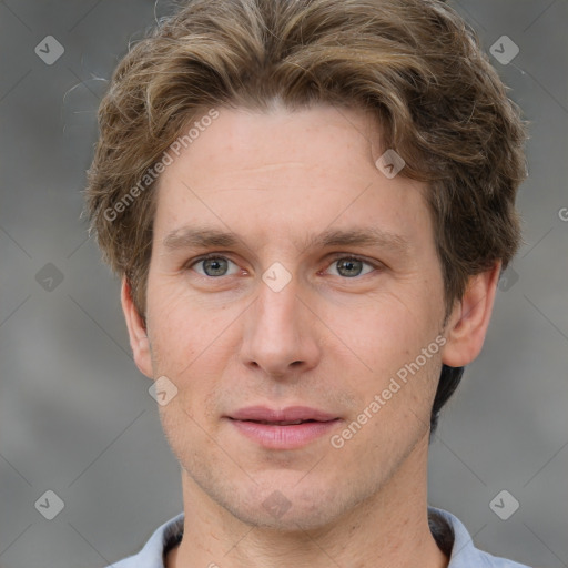 Joyful white adult male with short  brown hair and grey eyes