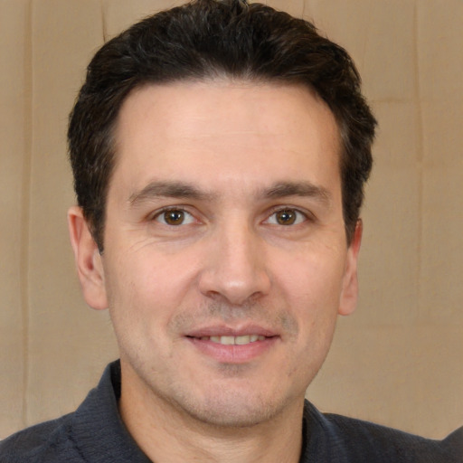 Joyful white adult male with short  brown hair and brown eyes