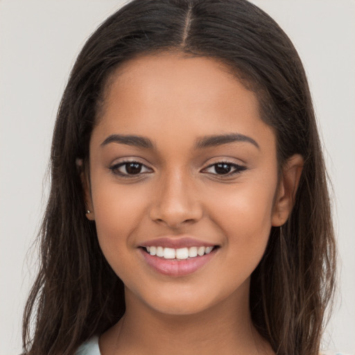 Joyful latino young-adult female with long  brown hair and brown eyes