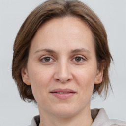 Joyful white adult female with medium  brown hair and grey eyes