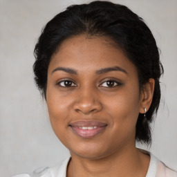 Joyful black young-adult female with medium  brown hair and brown eyes