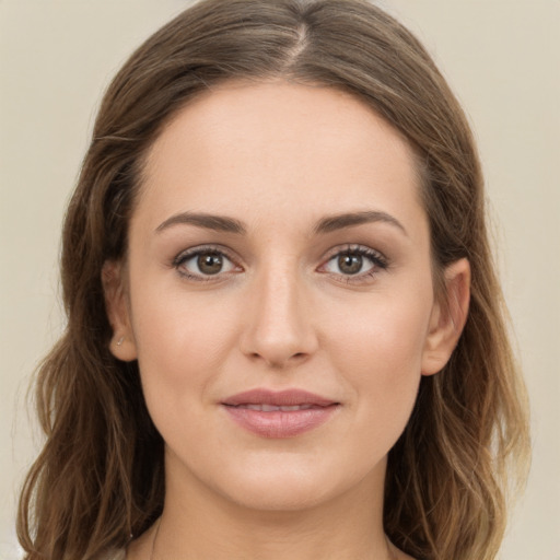 Joyful white young-adult female with long  brown hair and green eyes