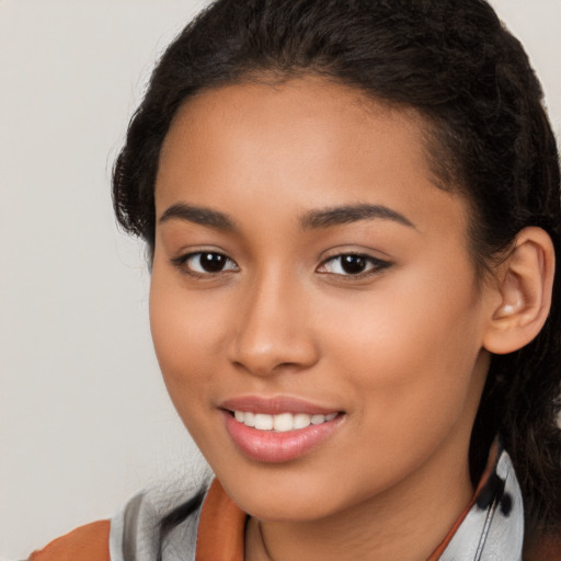 Joyful latino young-adult female with long  brown hair and brown eyes