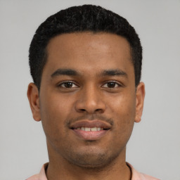 Joyful latino young-adult male with short  brown hair and brown eyes