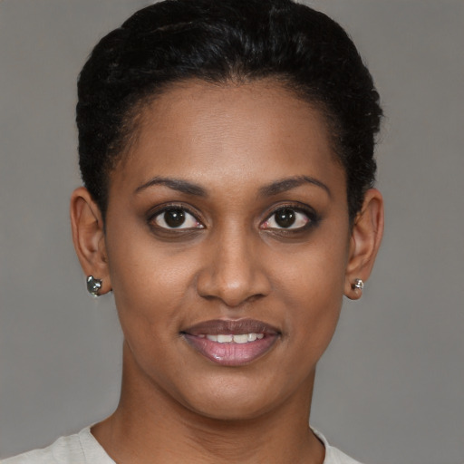 Joyful black young-adult female with short  brown hair and brown eyes