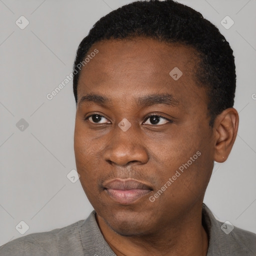 Joyful black young-adult male with short  black hair and brown eyes