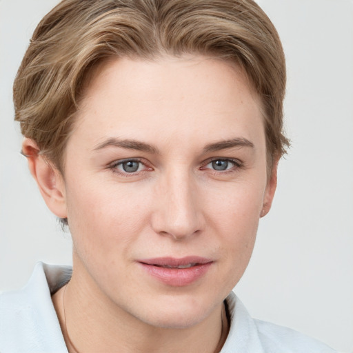 Joyful white young-adult female with short  brown hair and grey eyes