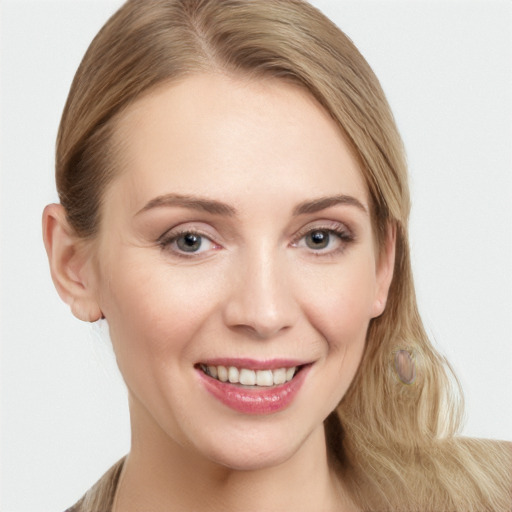 Joyful white young-adult female with long  brown hair and grey eyes