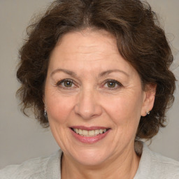 Joyful white middle-aged female with medium  brown hair and brown eyes