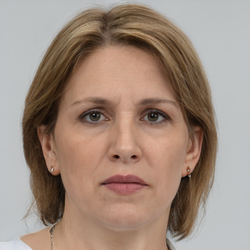 Joyful white adult female with medium  brown hair and grey eyes