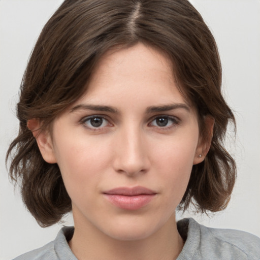 Neutral white young-adult female with medium  brown hair and brown eyes