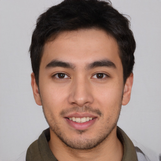 Joyful latino young-adult male with short  brown hair and brown eyes