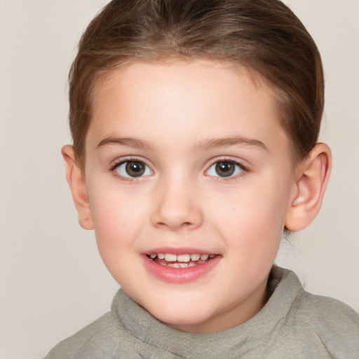 Joyful white child female with short  brown hair and brown eyes