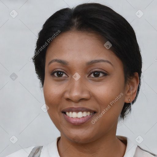 Joyful black young-adult female with medium  brown hair and brown eyes