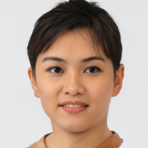 Joyful asian young-adult female with short  brown hair and brown eyes