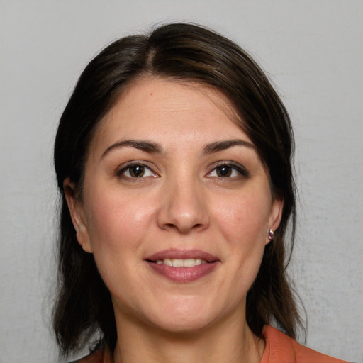 Joyful white young-adult female with medium  brown hair and brown eyes