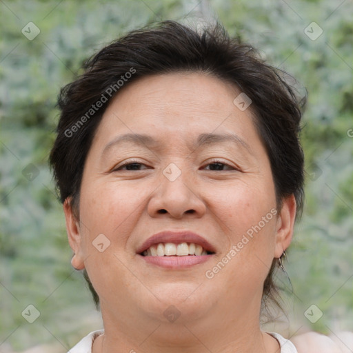 Joyful asian adult female with medium  brown hair and brown eyes