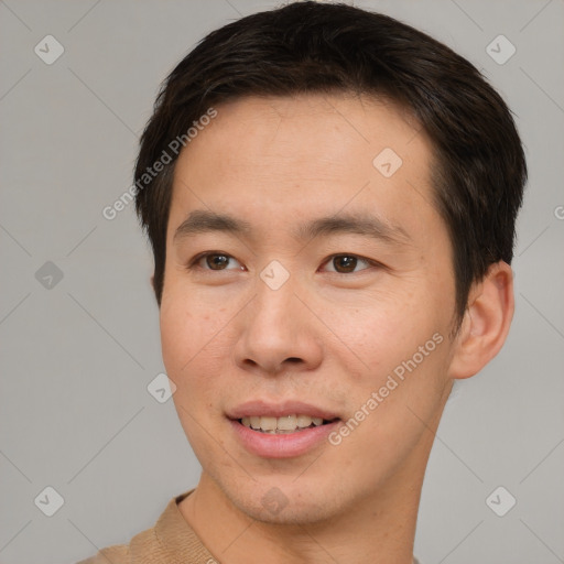 Joyful asian young-adult male with short  brown hair and brown eyes