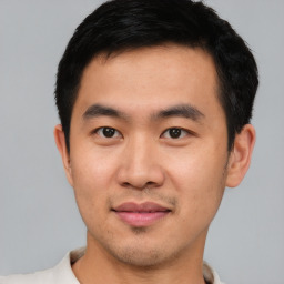 Joyful asian young-adult male with short  black hair and brown eyes