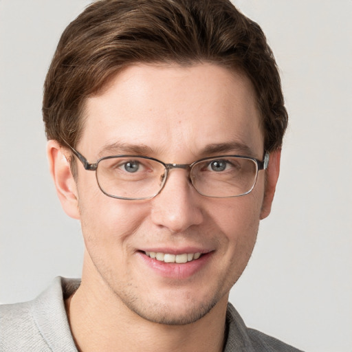 Joyful white adult male with short  brown hair and grey eyes