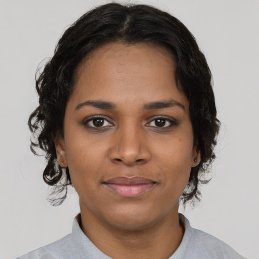 Joyful black young-adult female with short  brown hair and brown eyes