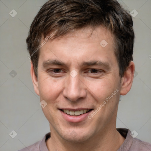 Joyful white adult male with short  brown hair and grey eyes