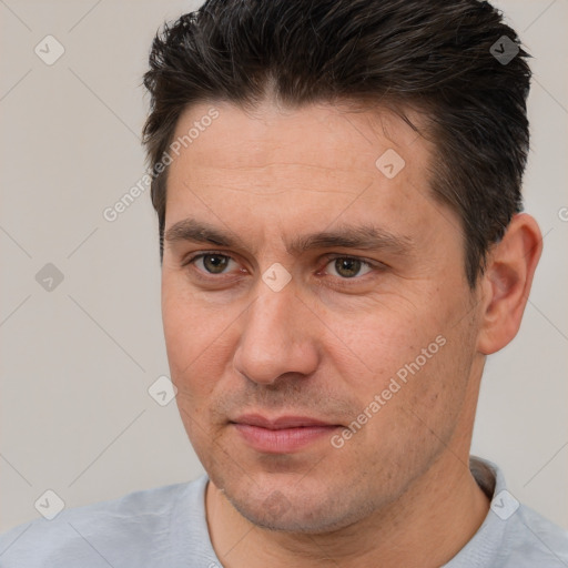 Joyful white adult male with short  brown hair and brown eyes