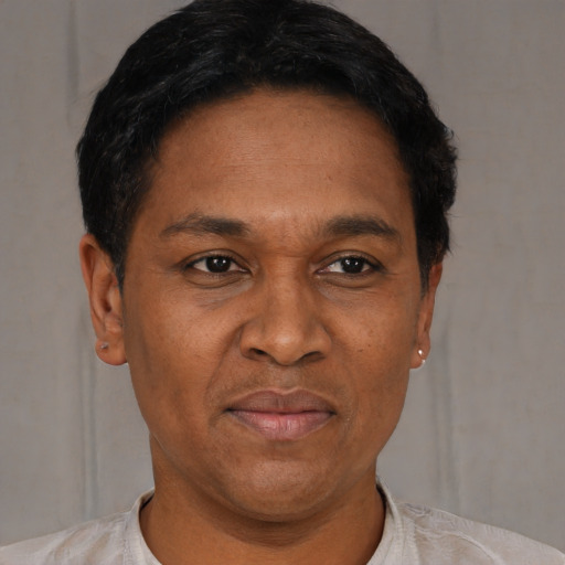 Joyful latino adult male with short  black hair and brown eyes