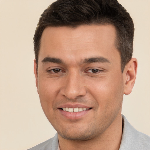 Joyful white young-adult male with short  brown hair and brown eyes