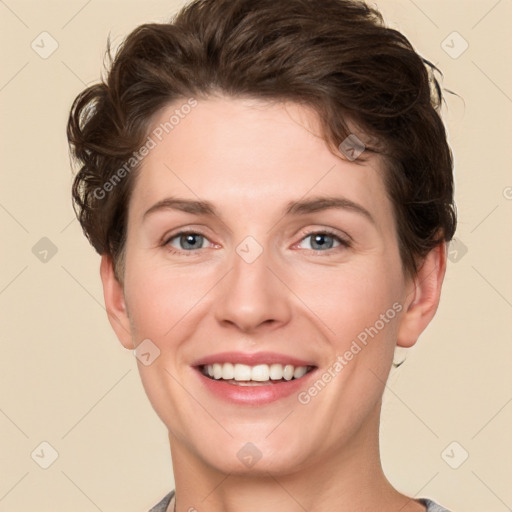 Joyful white young-adult female with short  brown hair and grey eyes