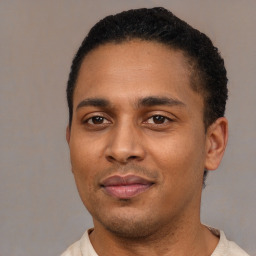 Joyful latino young-adult male with short  black hair and brown eyes