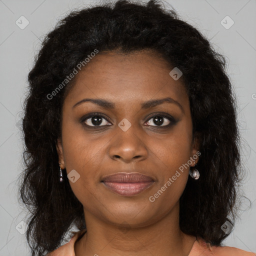 Joyful black young-adult female with long  brown hair and brown eyes