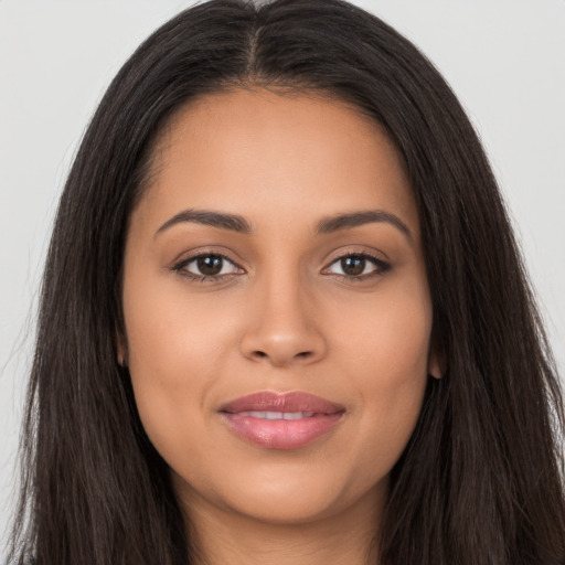 Joyful latino young-adult female with long  brown hair and brown eyes