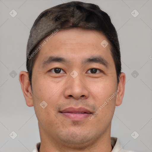 Joyful asian young-adult male with short  brown hair and brown eyes