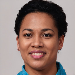 Joyful latino young-adult female with short  black hair and brown eyes