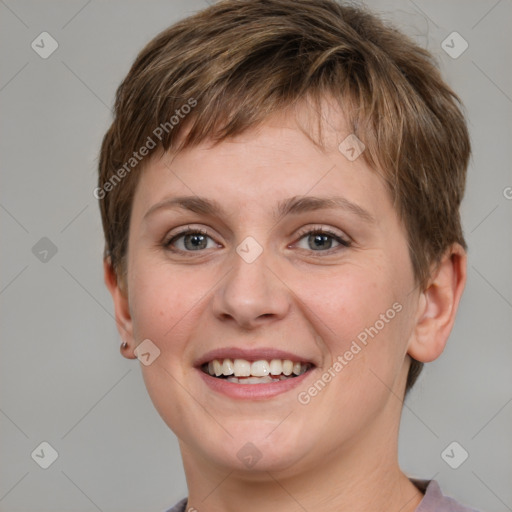 Joyful white young-adult female with short  brown hair and grey eyes