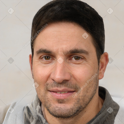 Joyful white adult male with short  brown hair and brown eyes