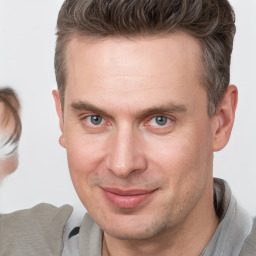 Joyful white adult male with short  brown hair and brown eyes